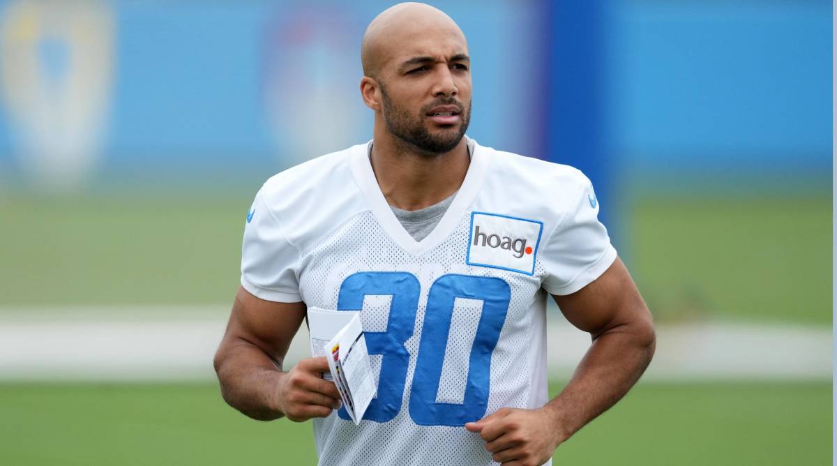 Chargers running back Austin Ekeler jogs without a helmet during practice.